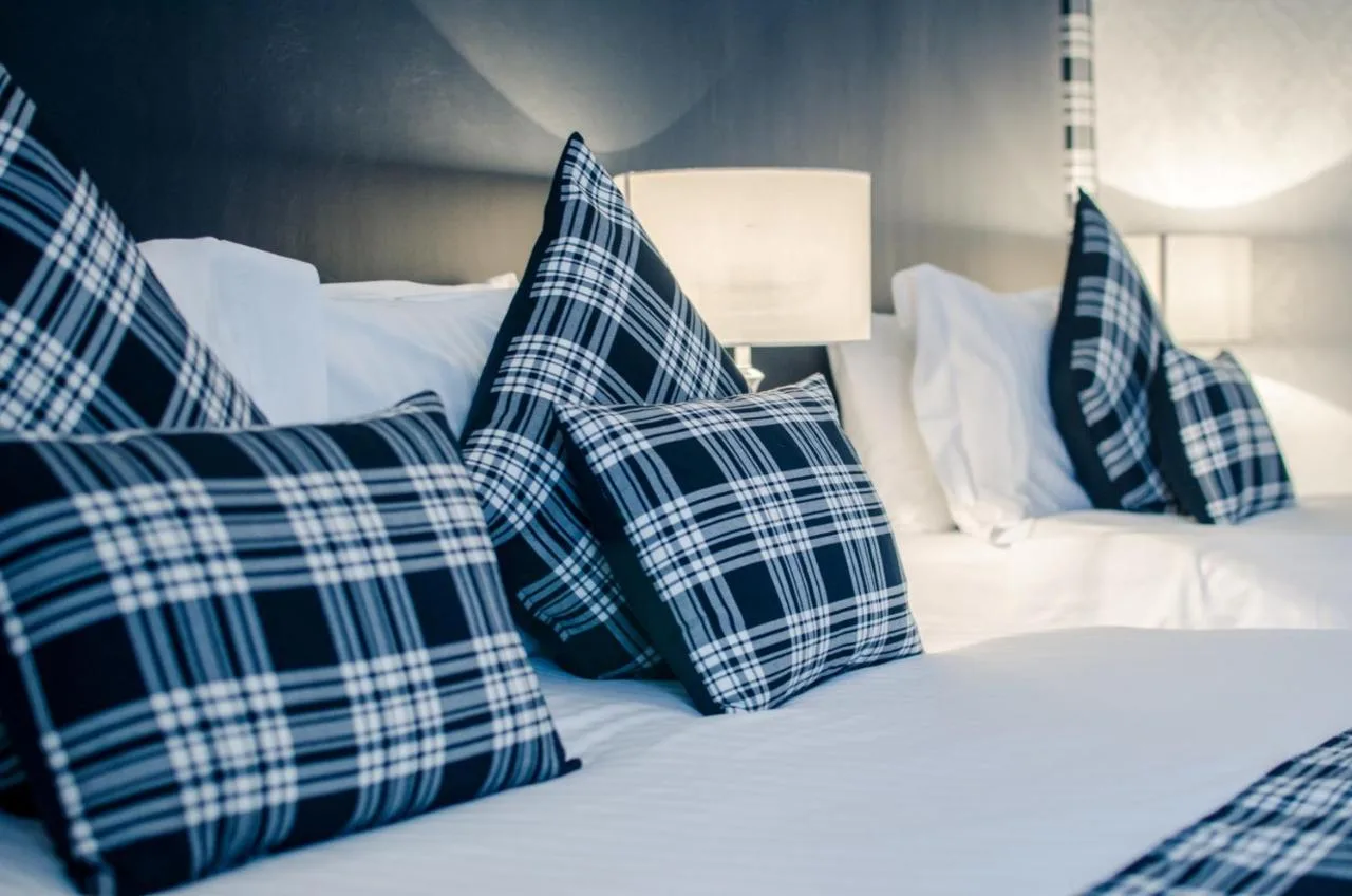 Tartan cushions on a bed